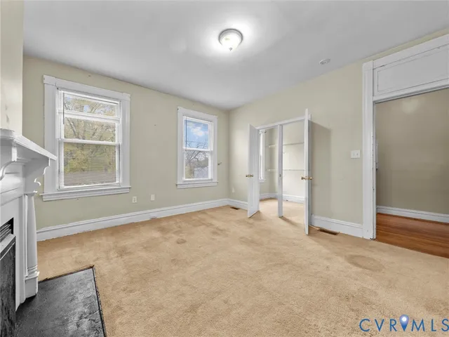 an empty room with windows and closet