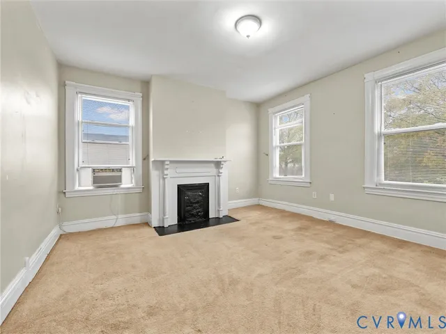 a view of an empty room with a fireplace