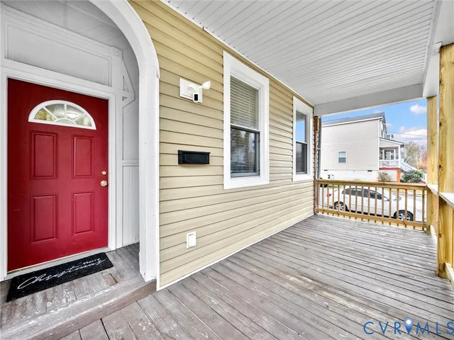a view of a balcony with a dinning table and chairs