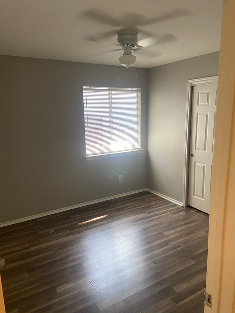 17616 Tobermory Drive Pflugerville, TX 78660 - Photo 11 of 14 A well-lit bedroom features durable plank flooring and a window for natural illumination.