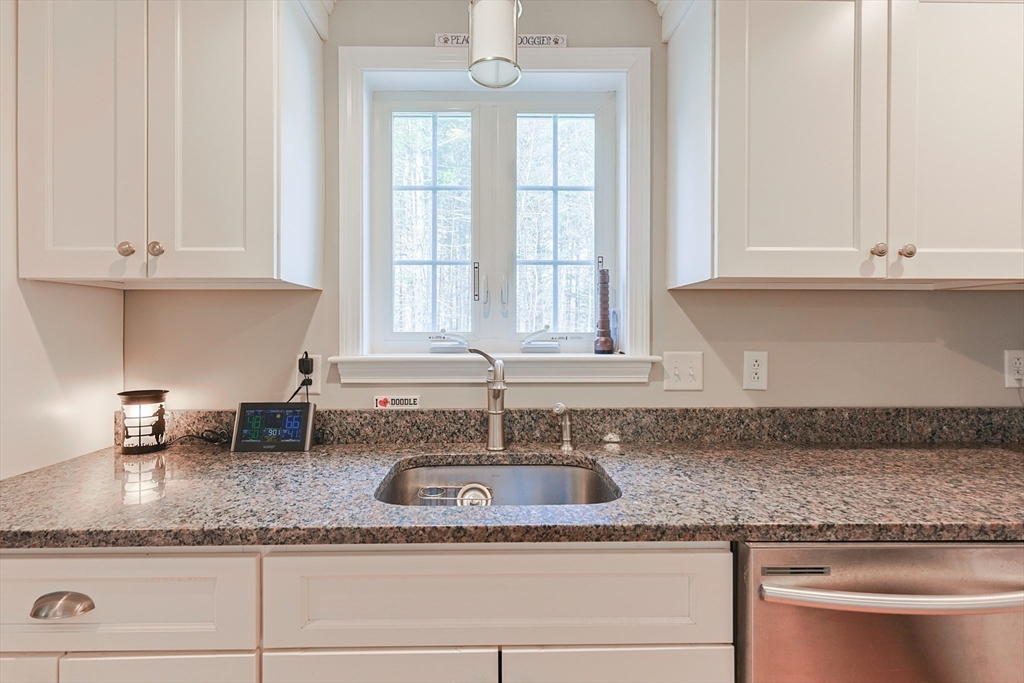 24 Reservoir Road Pembroke, MA 02359 - Photo 12 of 42 a kitchen with granite countertop stainless steel appliances white cabinets and a granite counter tops