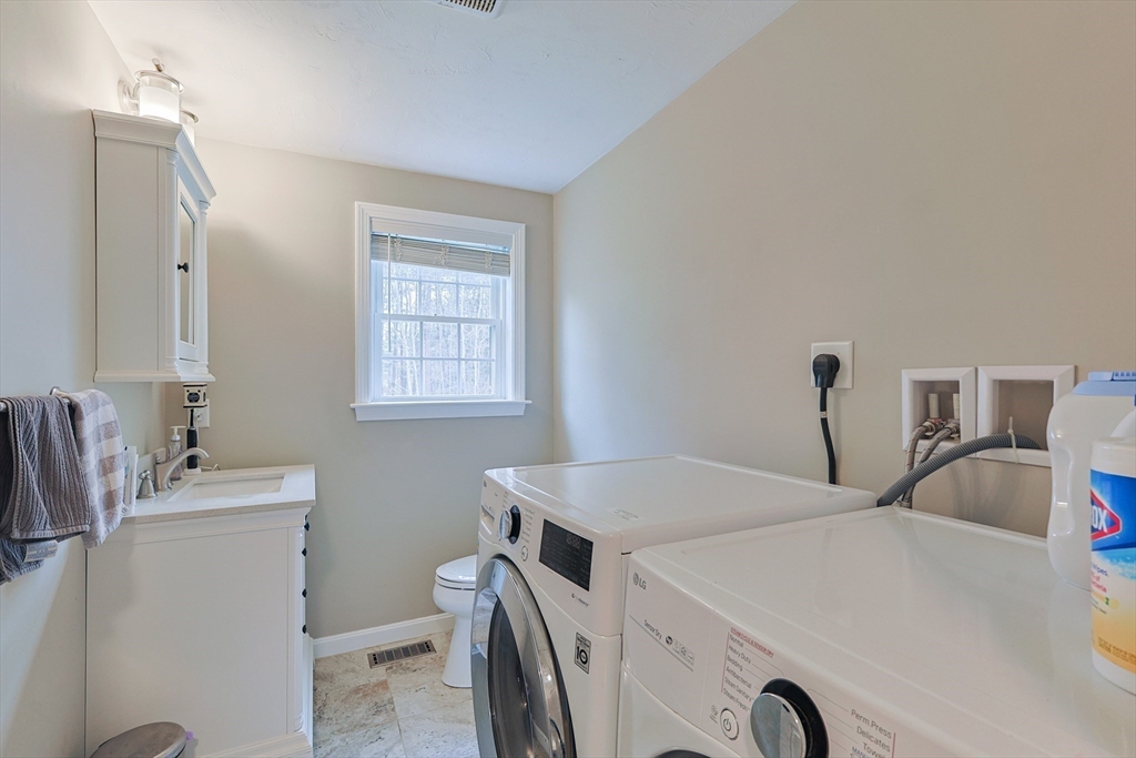 24 Reservoir Road Pembroke, MA 02359 - Photo 13 of 42 a utility room with dryer and washer