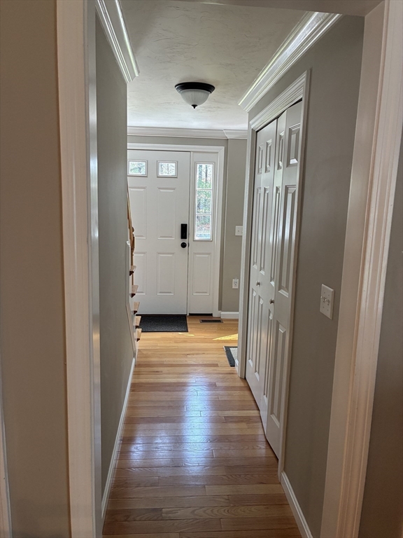 24 Reservoir Road Pembroke, MA 02359 - Photo 14 of 42 a view of a hallway with wooden floor and staircase