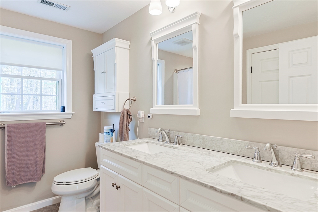 24 Reservoir Road Pembroke, MA 02359 - Photo 25 of 42 a bathroom with a granite countertop toilet sink and mirror