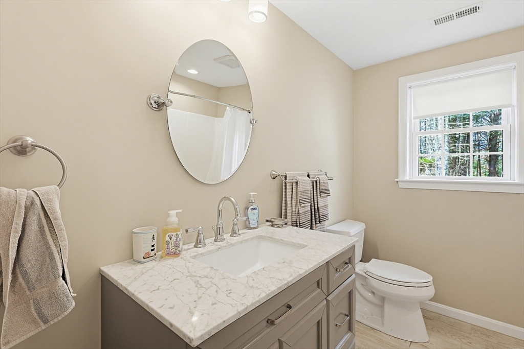 24 Reservoir Road Pembroke, MA 02359 - Photo 27 of 42 a bathroom with a granite countertop sink and a mirror