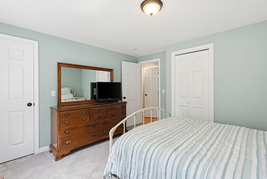 24 Reservoir Road Pembroke, MA 02359 - Photo 32 of 42 a bedroom with a bed and a television