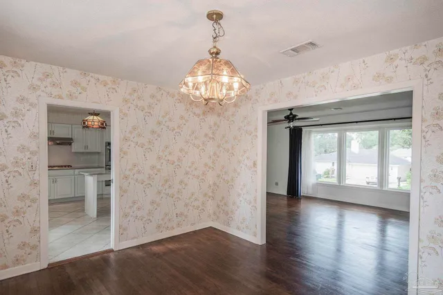 a kitchen with kitchen island granite countertop a sink stove and refrigerator