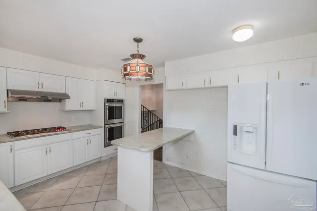 a view of house with backyard and sitting area