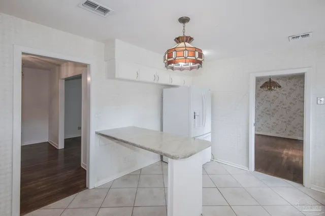a kitchen with stainless steel appliances white cabinets and a window