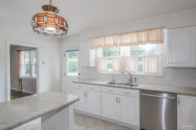 a view of a utility room with cabinets