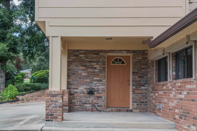 a front view of a house with a garden and yard