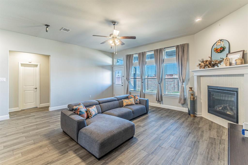 10638 Cherry Tree Way Grand Prairie, TX 76065 - Photo 5 of 39 Entertain here in this beautiful living room with natural light and electric fireplace