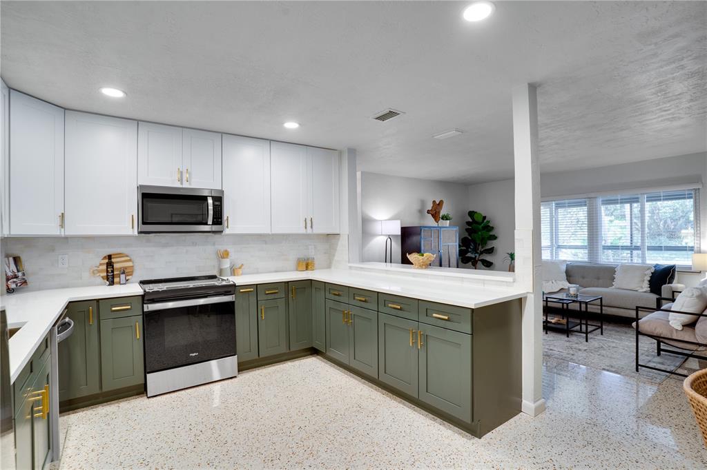 5135 101st Street North St. Petersburg, FL 33708 - Photo 13 of 46 a kitchen with a sink and cabinets