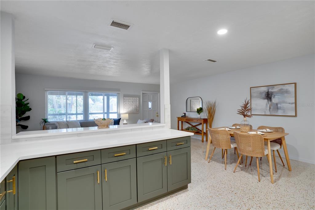 5135 101st Street North St. Petersburg, FL 33708 - Photo 14 of 46 a kitchen with a sink and a stove with wooden floors