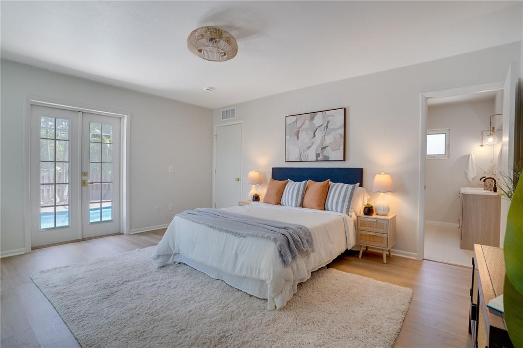 5135 101st Street North St. Petersburg, FL 33708 - Photo 18 of 46 a bedroom with a large bed and a window