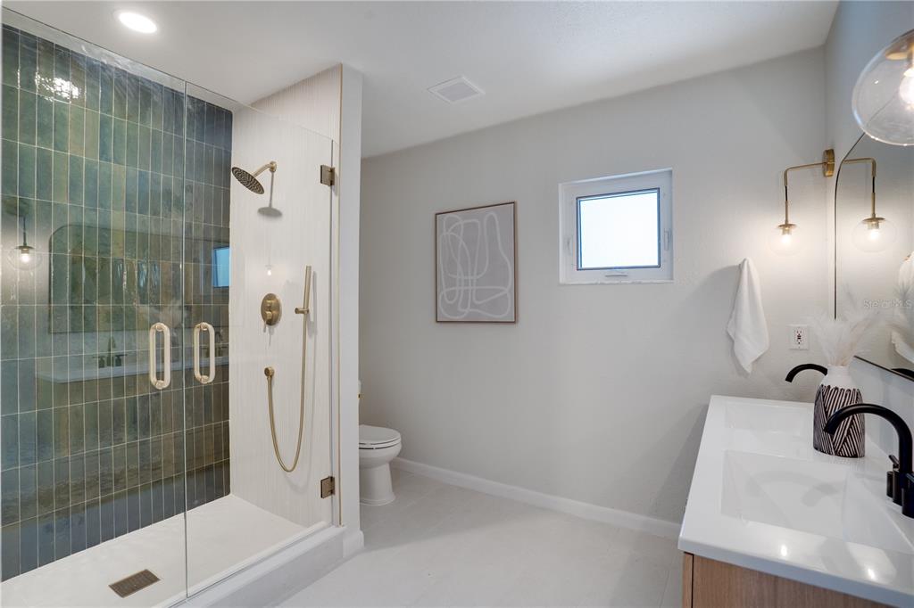 5135 101st Street North St. Petersburg, FL 33708 - Photo 21 of 46 a bathroom with a sink and a mirror