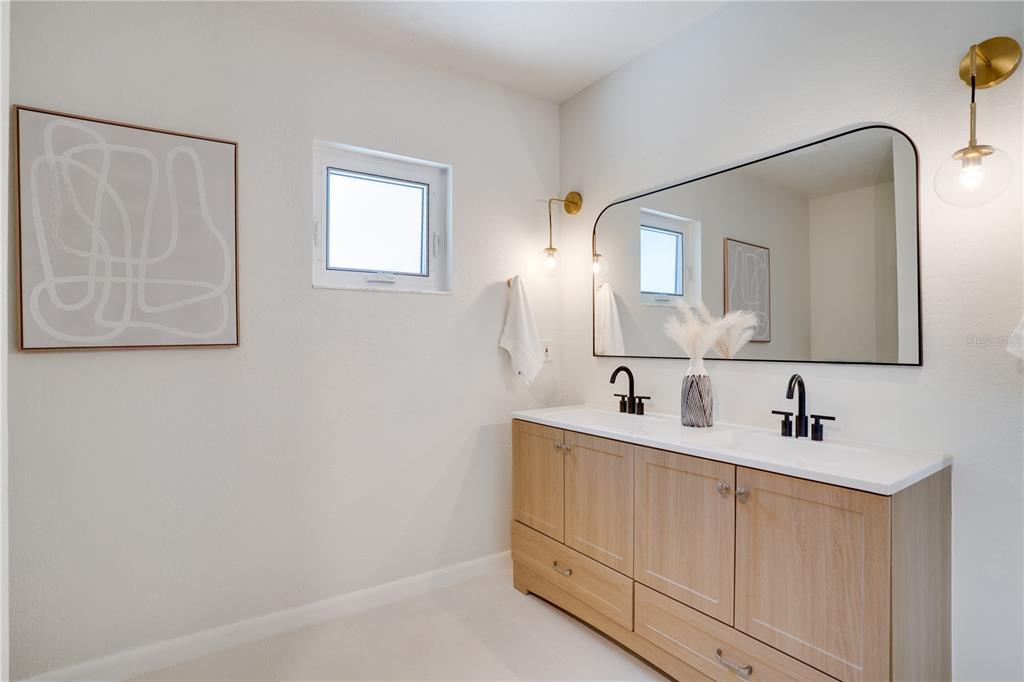 5135 101st Street North St. Petersburg, FL 33708 - Photo 22 of 46 a bathroom with 2 sink and a mirror