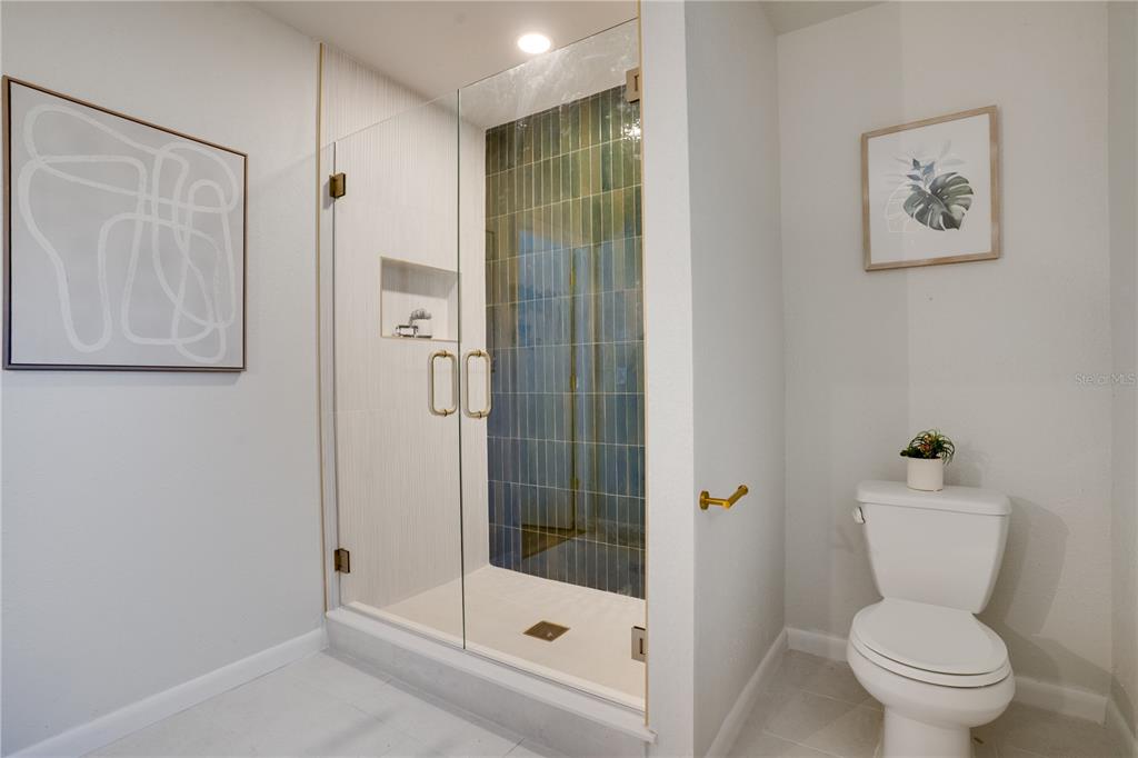 5135 101st Street North St. Petersburg, FL 33708 - Photo 23 of 46 a bathroom with a shower and toilet