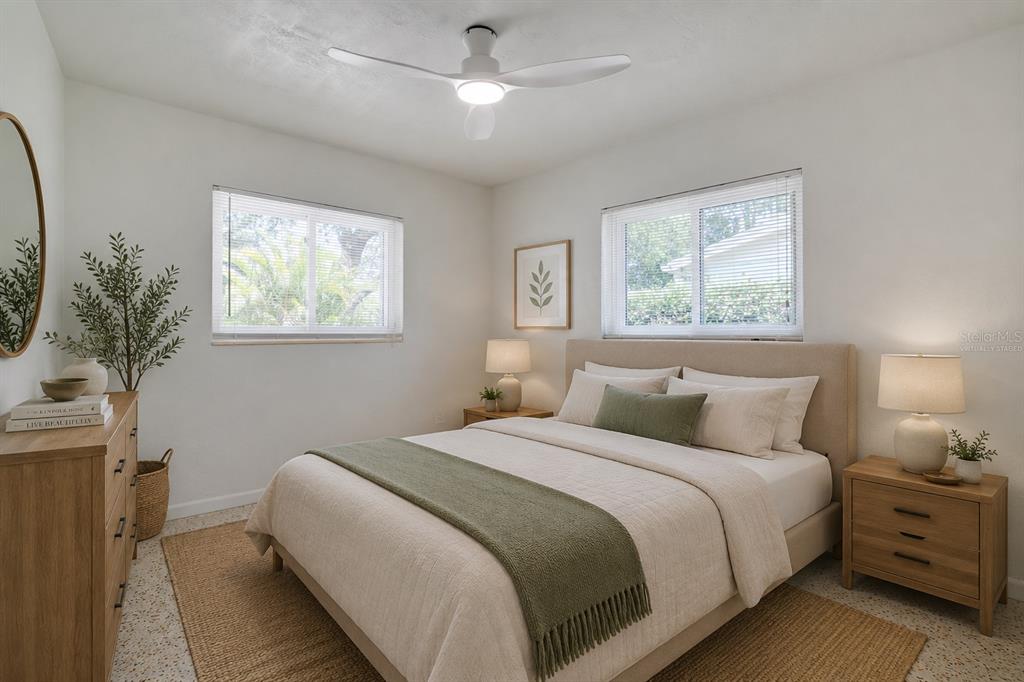 5135 101st Street North St. Petersburg, FL 33708 - Photo 27 of 46 a bedroom with bed and a potted plant