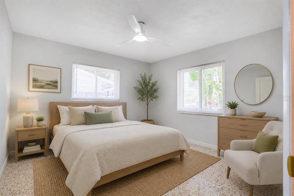 5135 101st Street North St. Petersburg, FL 33708 - Photo 28 of 46 a bedroom with a bed and a couch