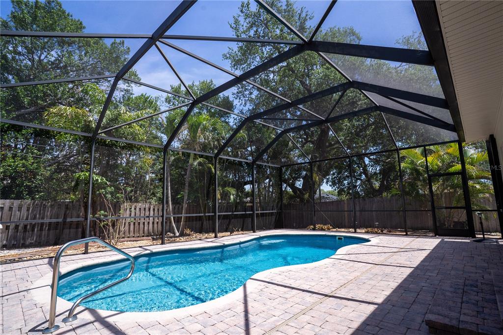 5135 101st Street North St. Petersburg, FL 33708 - Photo 32 of 46 a view of backyard with swimming pool and outdoor seating