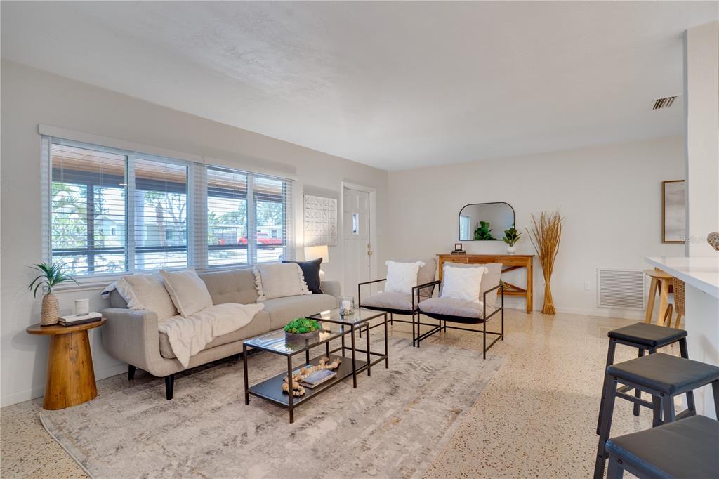 5135 101st Street North St. Petersburg, FL 33708 - Photo 9 of 46 a living room with furniture and a large window