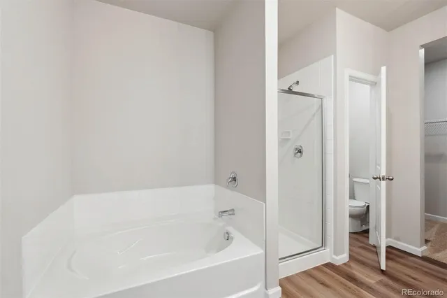 a white bath tub sitting next to a shower