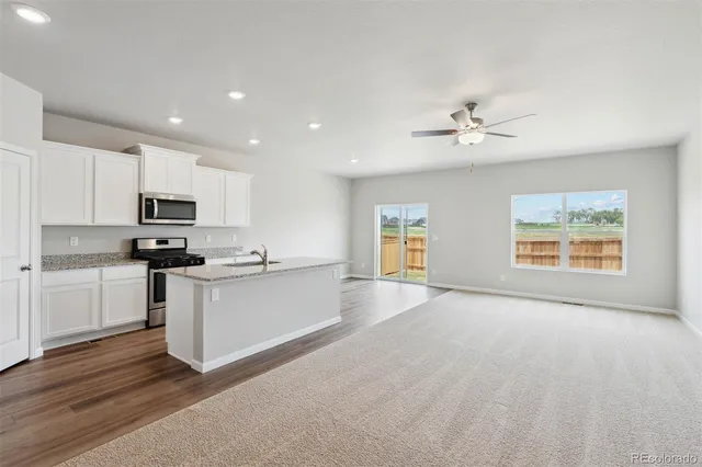 a view of kitchen with sink and microwave