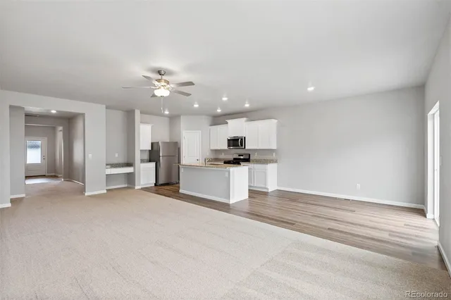 a view of kitchen with refrigerator and window