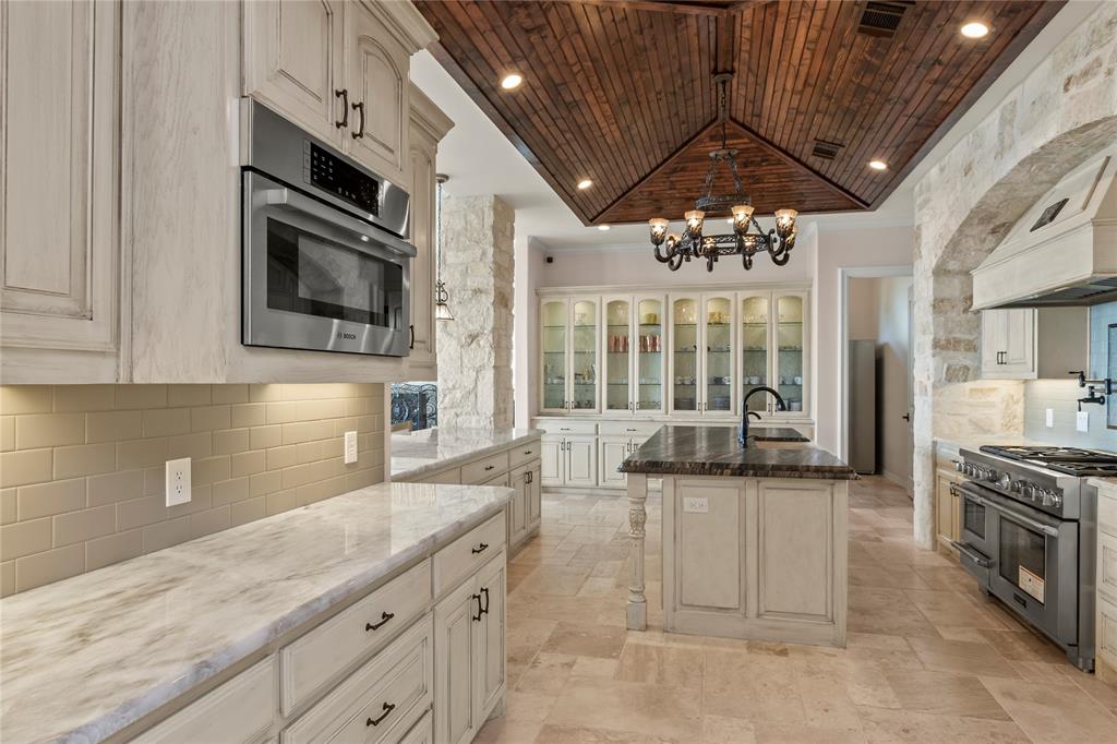 204 Pinnacle Club Place Mabank, TX 75156 - Photo 13 of 40 a large kitchen with stainless steel appliances granite countertop a sink and cabinets
