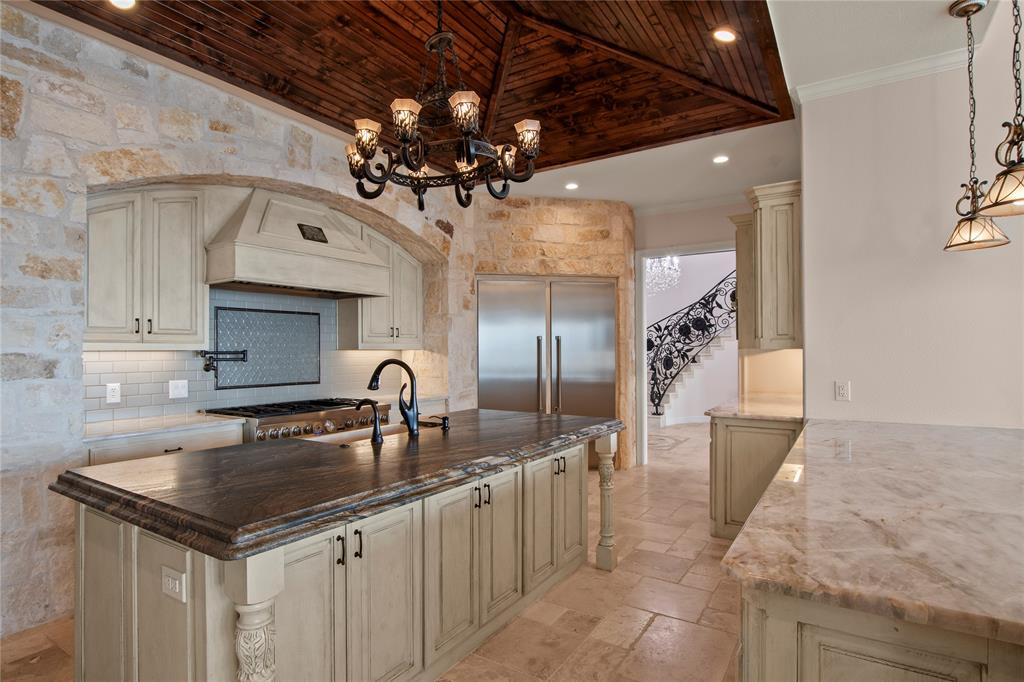 204 Pinnacle Club Place Mabank, TX 75156 - Photo 14 of 40 a kitchen with a sink a counter space cabinets and stainless steel appliances