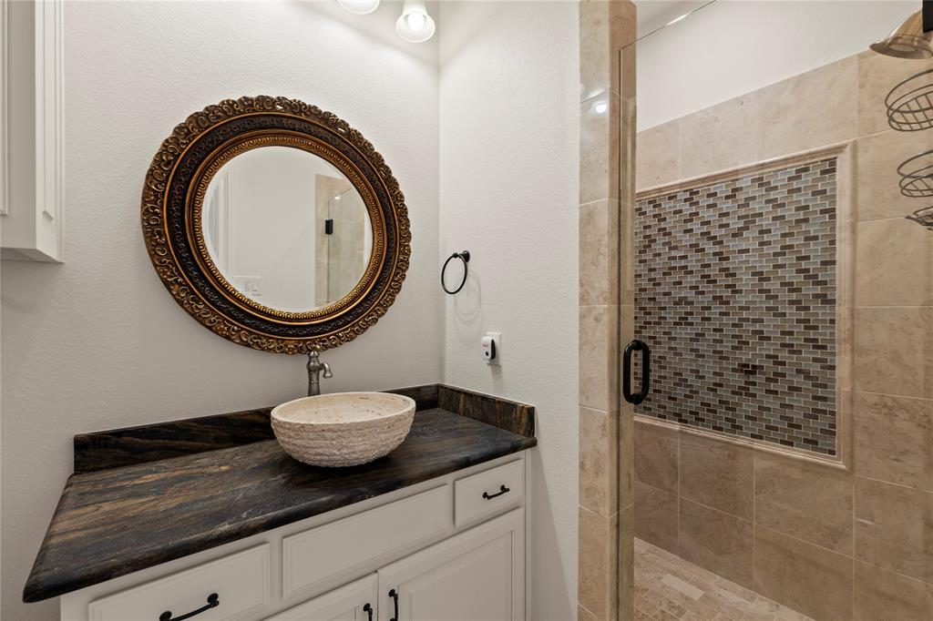 204 Pinnacle Club Place Mabank, TX 75156 - Photo 19 of 40 a bathroom with a granite countertop sink and a mirror