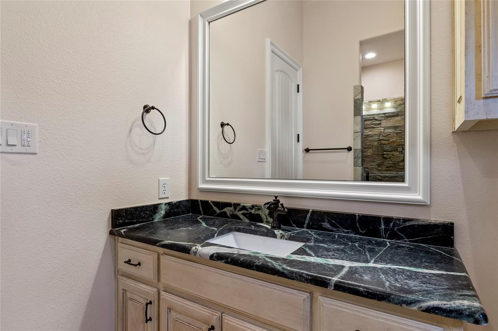 204 Pinnacle Club Place Mabank, TX 75156 - Photo 20 of 40 a bathroom with a granite countertop sink and a mirror