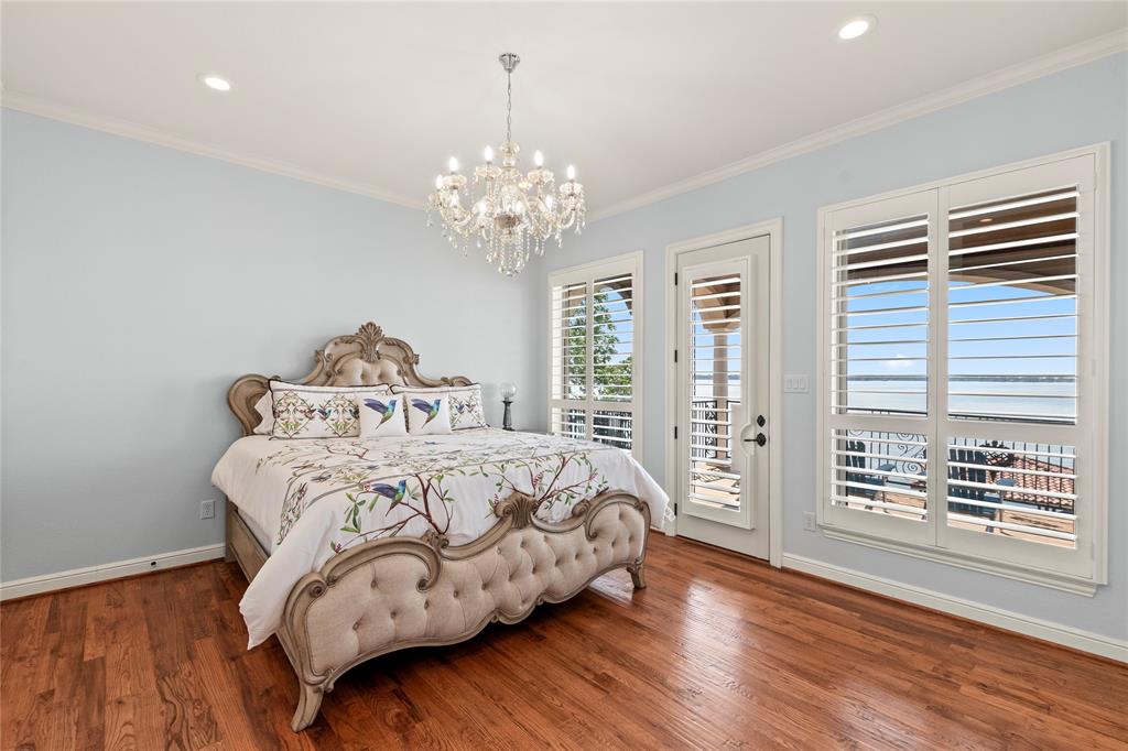 204 Pinnacle Club Place Mabank, TX 75156 - Photo 24 of 40 a bedroom with a bed and a wooden floor