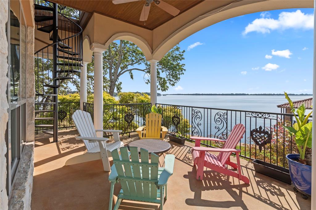 204 Pinnacle Club Place Mabank, TX 75156 - Photo 33 of 40 a balcony with couple of chairs and wooden floor