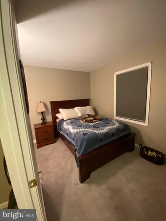 a bedroom with a bed and a mirror