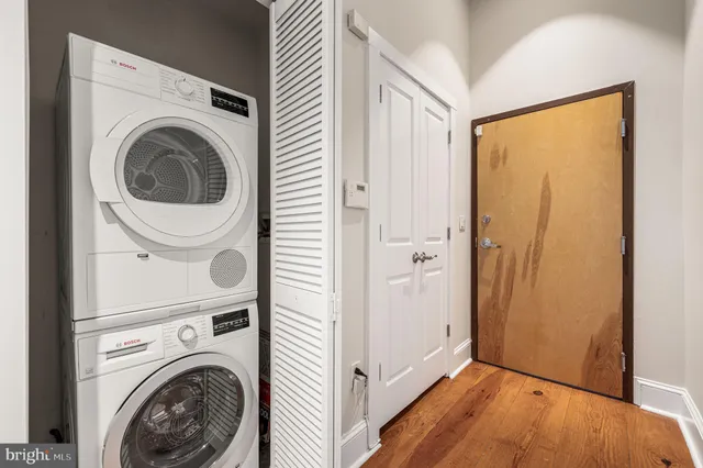 a view of a hallway with washer and dryer