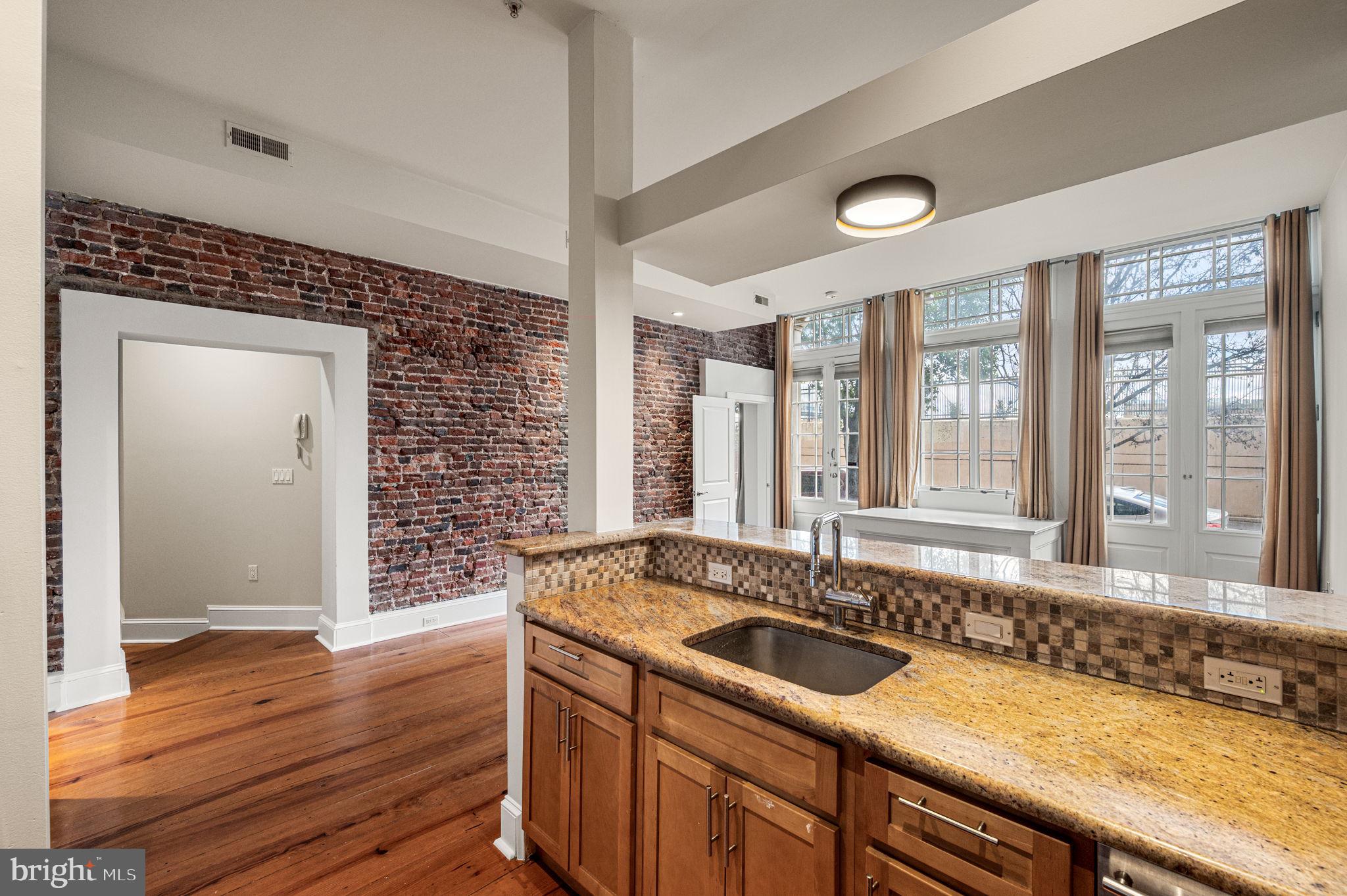 38 North Front Street, Unit 1F Philadelphia, PA 19106 - Photo 5 of 12 a bathroom with a granite countertop sink and a large mirror