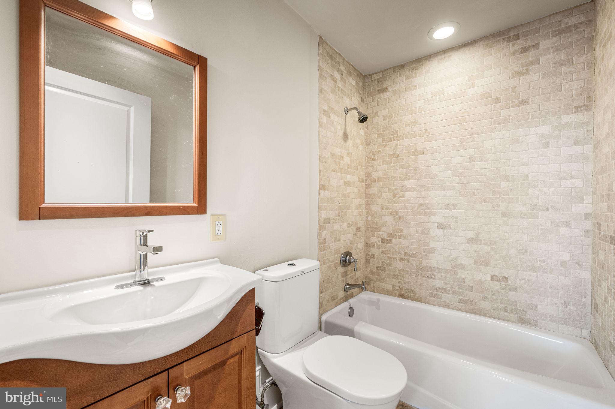38 North Front Street, Unit 1F Philadelphia, PA 19106 - Photo 6 of 12 a bathroom with a sink a toilet and shower