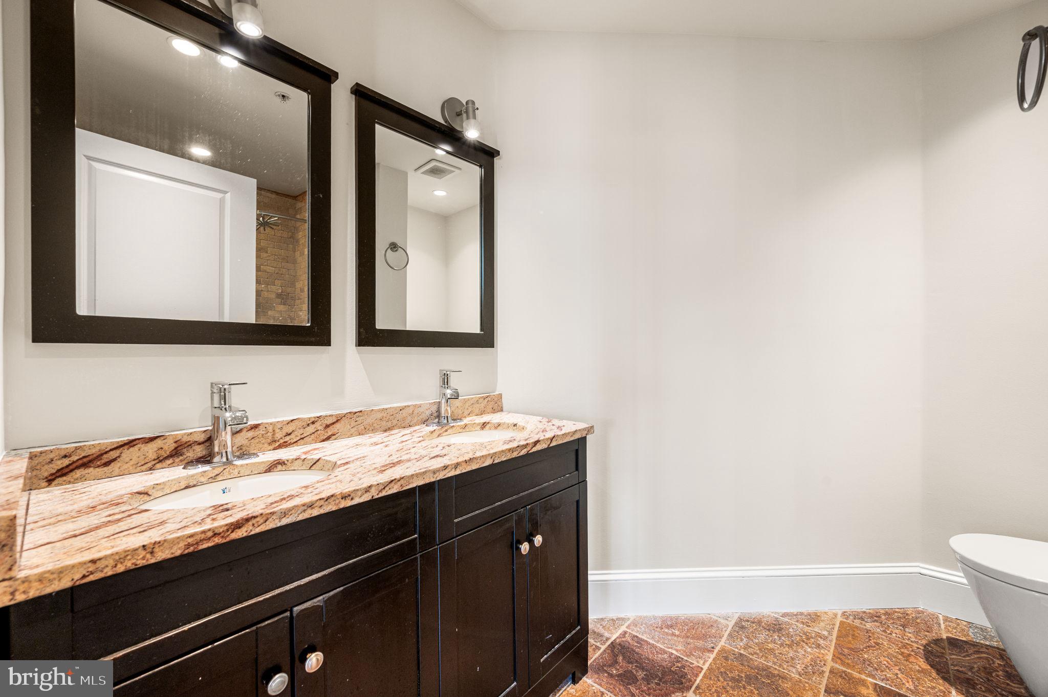 38 North Front Street, Unit 1F Philadelphia, PA 19106 - Photo 9 of 12 a bathroom with a sink and a mirror