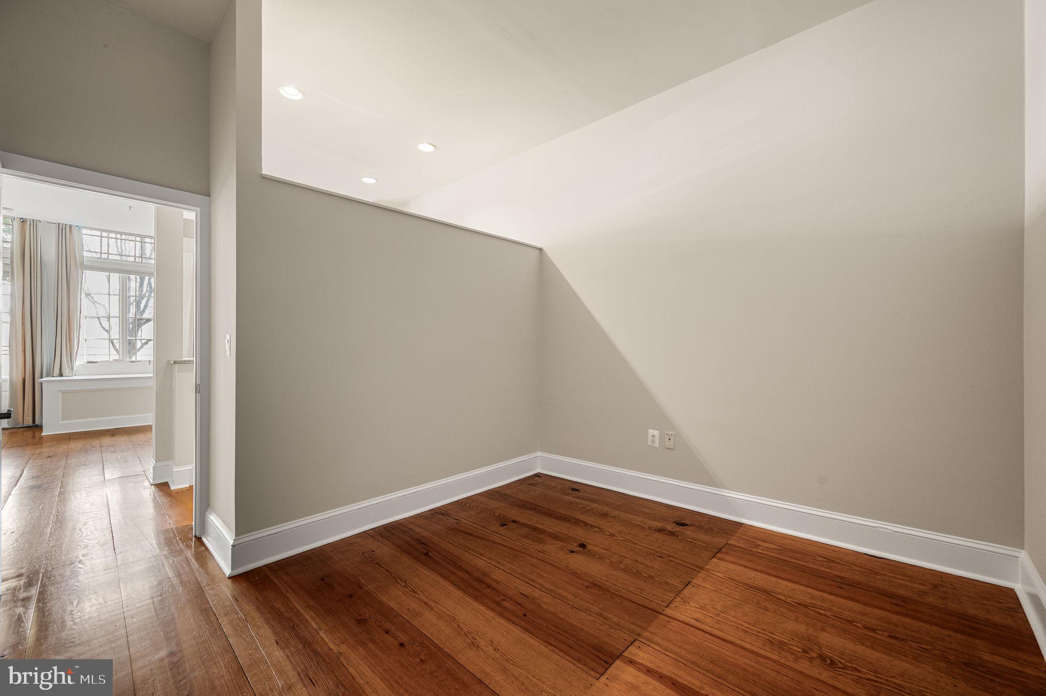 38 North Front Street, Unit 1F Philadelphia, PA 19106 - Photo 10 of 12 wooden floor in an empty room with a window