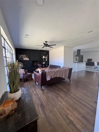 a living room with furniture a fireplace and gym equipment