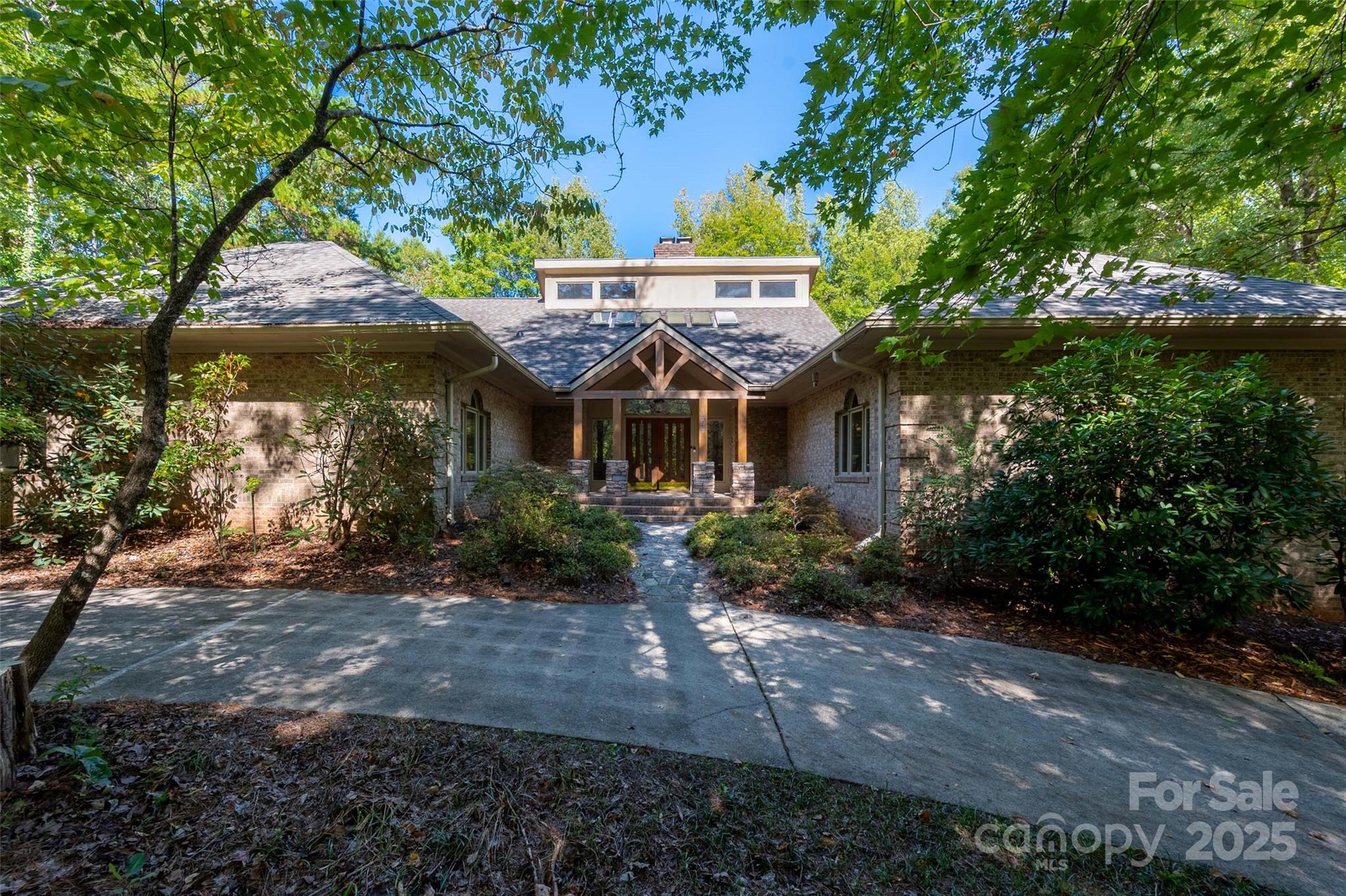 909 Baron Road Waxhaw, NC 28173 - Photo 1 of 46 a front view of a house with a garden