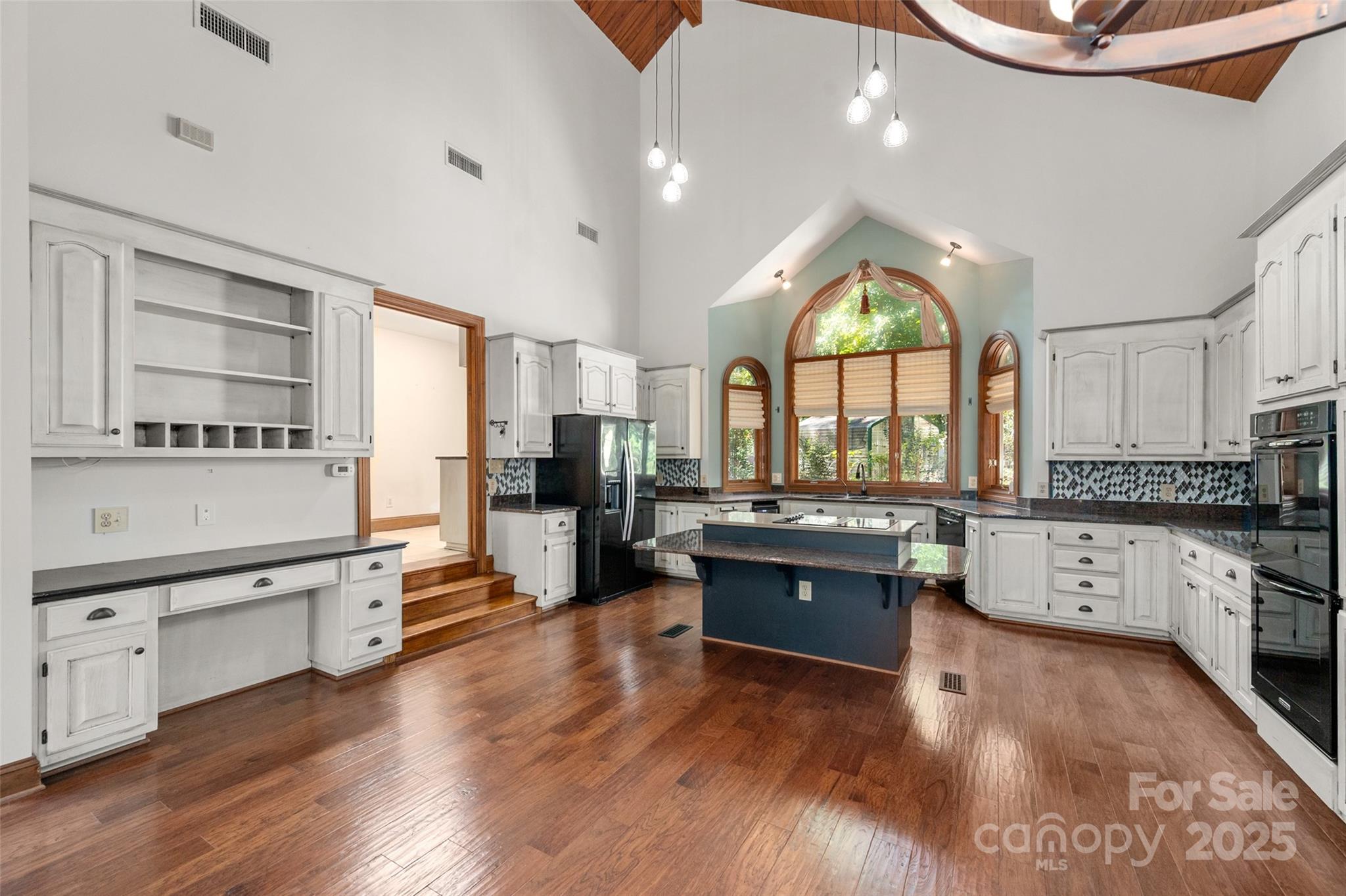 909 Baron Road Waxhaw, NC 28173 - Photo 11 of 46 a large kitchen with stainless steel appliances granite countertop a stove and wooden floor