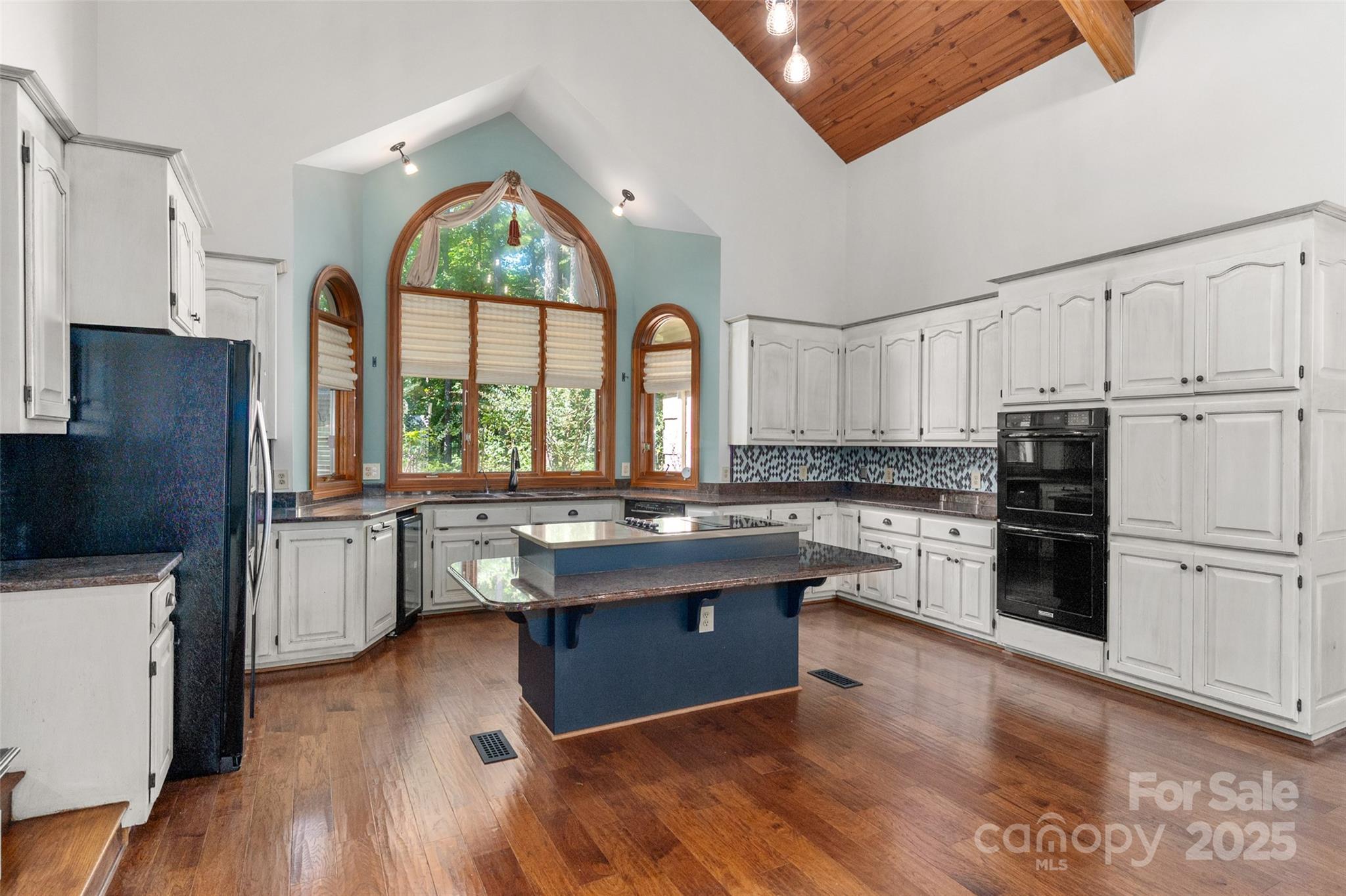 909 Baron Road Waxhaw, NC 28173 - Photo 12 of 46 a kitchen with kitchen island granite countertop a stove top oven and refrigerator