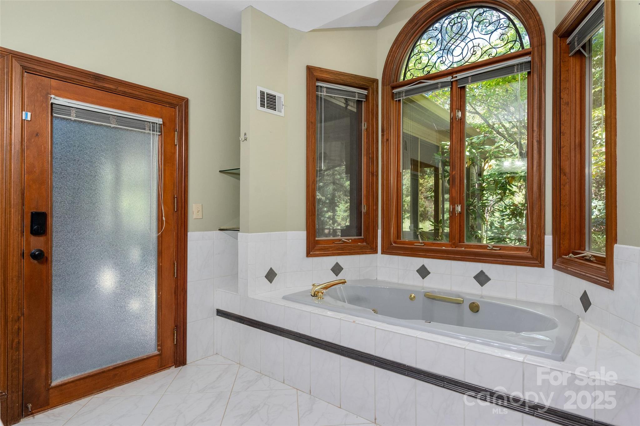 909 Baron Road Waxhaw, NC 28173 - Photo 20 of 46 a bathroom with a tub and a large window