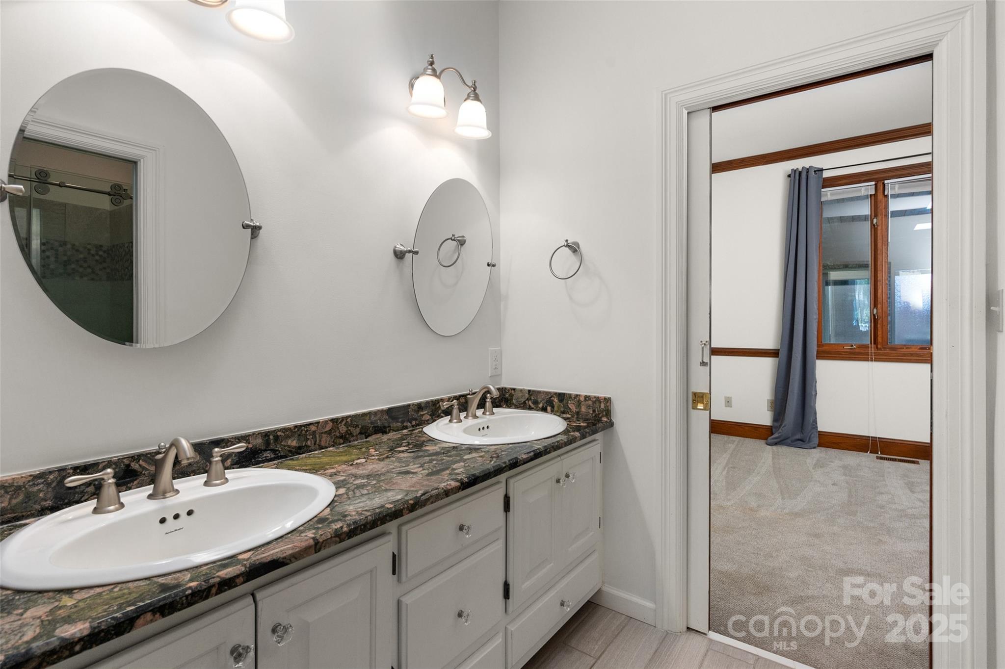 909 Baron Road Waxhaw, NC 28173 - Photo 25 of 46 a bathroom with a granite countertop double vanity sink and a mirror