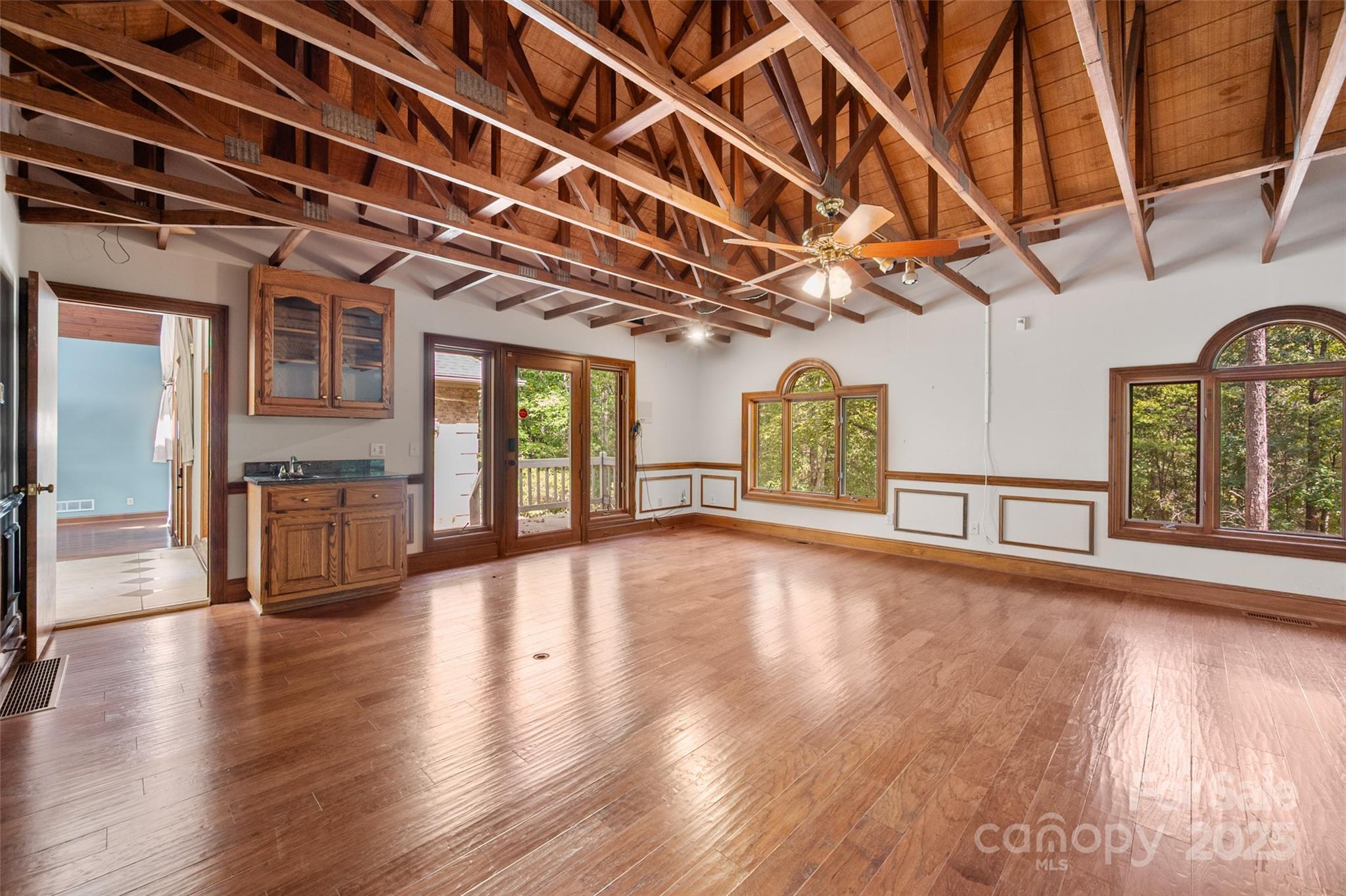909 Baron Road Waxhaw, NC 28173 - Photo 31 of 46 a view of an empty room with wooden floor and a window