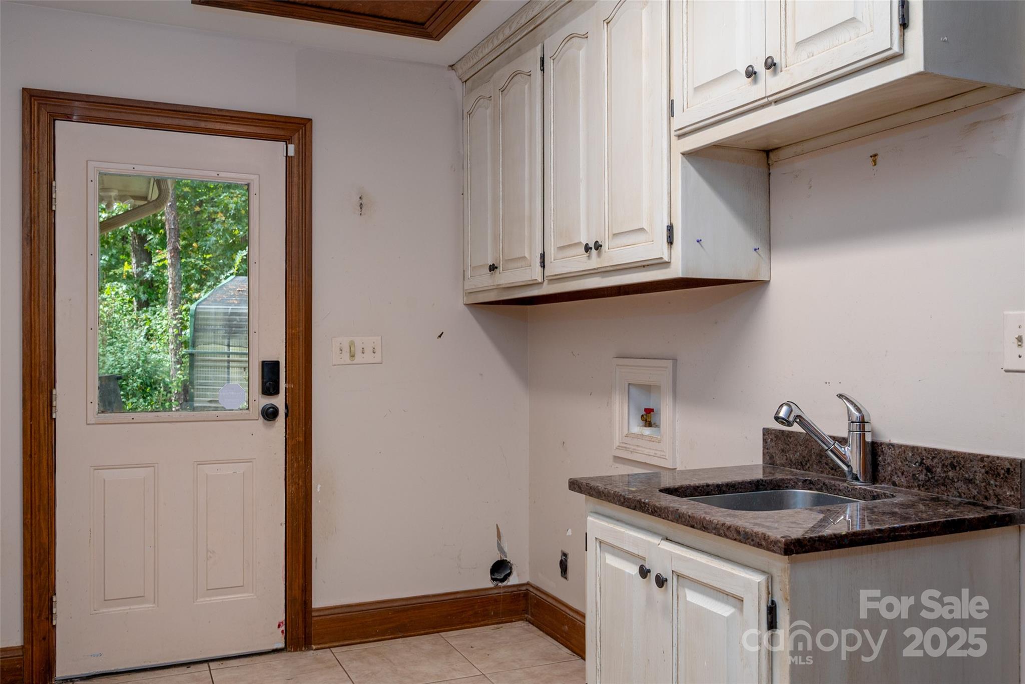 909 Baron Road Waxhaw, NC 28173 - Photo 33 of 46 a kitchen with granite countertop a sink and a stove next to a window