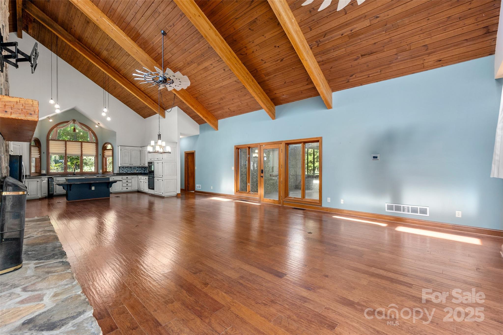 909 Baron Road Waxhaw, NC 28173 - Photo 8 of 46 a view of empty room with wooden floor and fan